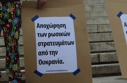 a couple of people standing next to each other holding signs